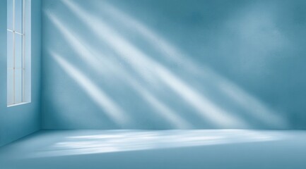 Empty blue room with sunlight streaming through a window