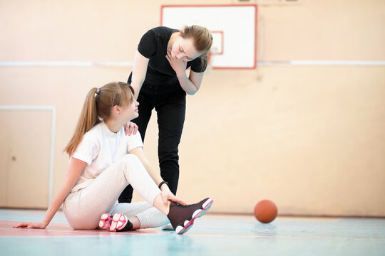 Girl in the gym playing a basketball