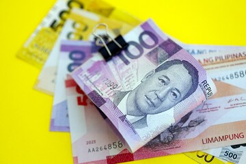 Philippines peso money bills in big amount on yellow. Finance and banking concept