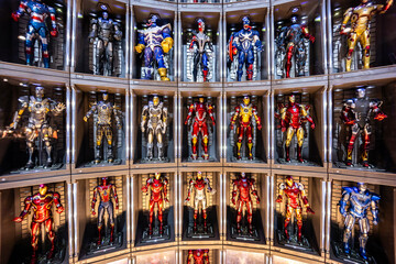 Naklejka premium Bangkok, Thailand - September 4, 2025 : A display of multiple iconic Iron Man, Venom and Spider Man suits arranged in a futuristic setup. Avenger Marvel Concept.