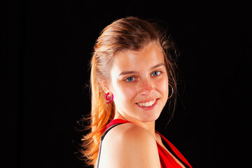 Young and beautiful woman at studio with black backgound