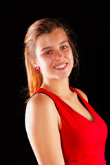 Young and beautiful woman at studio with black backgound