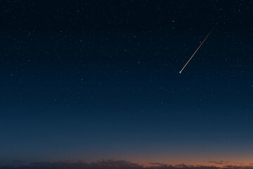 Bright shooting star is streaking across the night sky. The sky is dark and filled with stars