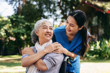 Fototapeta premium A woman in a wheelchair is being comforted by a woman in a blue uniform