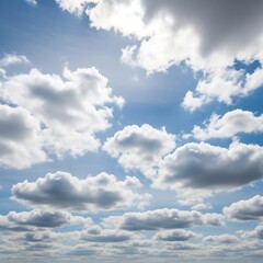 Obraz premium A bright blue sky is dotted with puffy white clouds, showcasing a beautiful and serene day.