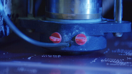 Close up of an industrial laser engraver meticulously etching intricate patterns onto a metal surface, showcasing the advanced technology and precision of modern manufacturing processes