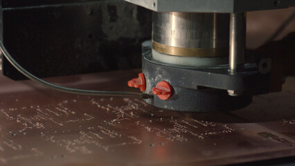 Close up of a milling machine carefully engraving an electronic circuit board, showcasing the precision and intricacy of modern manufacturing processes in an industrial environment