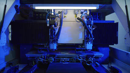 Sophisticated industrial laser cutter precisely processing material on a production line, illuminated by intense blue light in a modern factory setting, showcasing advanced manufacturing technology