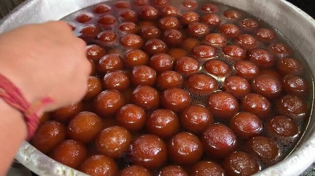 Fresh Gulab Jamun being packed from a container in Bihar