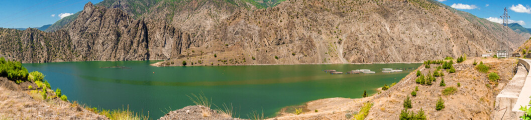 14 July 2025 Tortum Erzurum. Tortum waterfall, tortum dam, lake and fish farms on the lake on a sunny day.