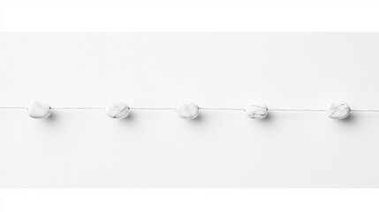 A white string with four white marbled beads.