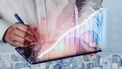 A business professional writes on a tablet, analyzing data trends with digital overlays set against a city backdrop, symbolizing growth and innovation in finance. Copula