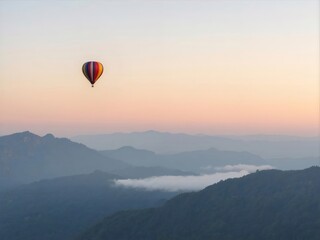 Sunrise Hot Air Balloon Floating Over Layered Mountain Ranges in Blue Pink Sky