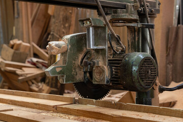 Old industrial radial arm saw in woodshop