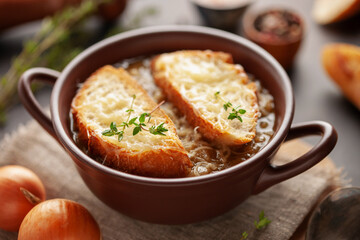 Classic French onion soup baked with cheese croutons sprinkled with fresh thyme