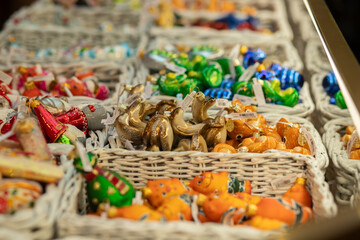 Christmas tree decorations toys on Christmas market, glossy baubles and sparkling garlands, cheerful shopping for seasonal decorations.,Russia, Moscow, December 16, 2024
