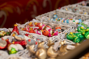 Obraz premium Christmas tree decorations toys on Christmas market, shiny baubles and unique ornaments in a basket, seasonal holiday decor and vibrant spirit,Russia, Moscow, December 16, 2024