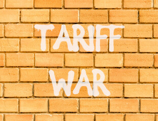 Trade tariff war symbol. Concept word Tariff war on beautiful brown brick wall. Beautiful brown...