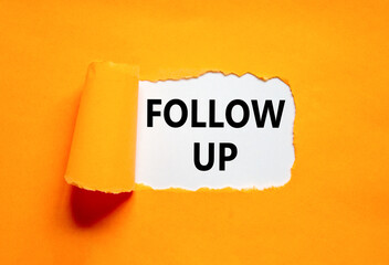 Follow up symbol. Concept word Follow up on beautiful white paper. Beautiful orange paper background. Business follow up concept. Copy space.