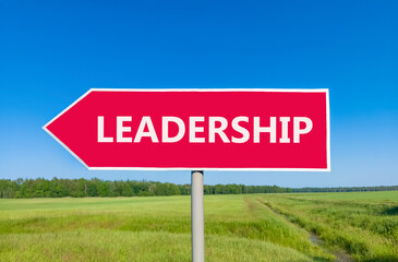 Leadership symbol. Concept word Leadership on beautiful red road sign. Beautiful blue sky green grass and forest peaceful nature background. Business leadership concept. Copy space.