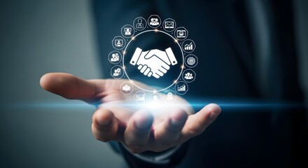 Hand holding glowing digital handshake icon with surrounding business symbols