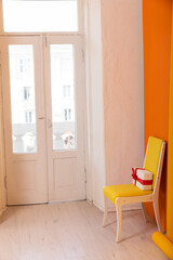 chair with gift in the interior of a yellow orange room