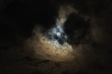 Full moon in the night sky with clouds, closeup of photo