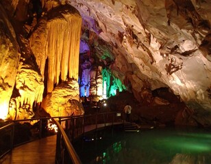 Illuminated cave formations with walkway