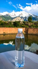 Plastic water bottle on a table, mountains and a pond in the background