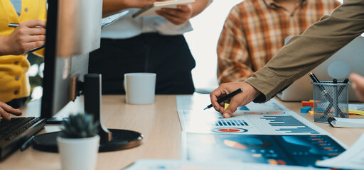 A diverse team engages in a dynamic meeting, analyzing data and developing strategies. The collaborative atmosphere showcases modern office tools and effective communication. SACTR