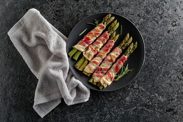 Grilled green asparagus wrapped in bacon.