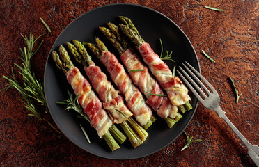 Grilled green asparagus wrapped in bacon.