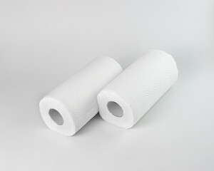 Two rolls of paper towels are lying on the surface