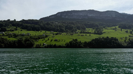 Mountain Lake Panorama with Rocky Island Ridge — Calm Water Ripples and Blue Sky with High Clouds, Scenic Nature Travel Background