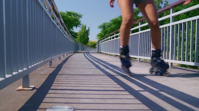 Roller skating woman enjoys her free time in a sunny park