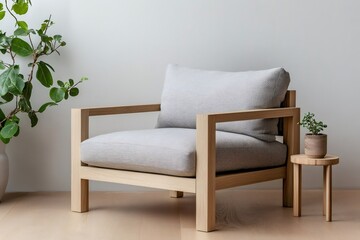Modern scandinavian armchair with light wooden frame and soft grey cushions in a cozy interior with green plants, promoting relaxation and comfortable living