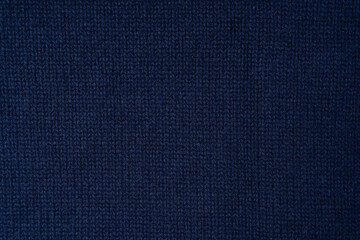 Navy blue merino wool sweater texture as background. Top view.