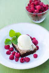 Chocolate brownie with raspberry and mint served with ice cream dessert