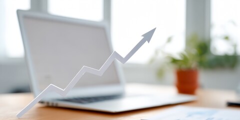 Laptop with a graph on it showing a rising line