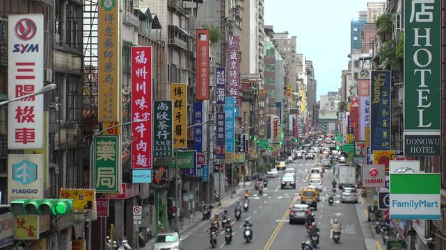 TAIPEI, TAIWAN - AUGUST 2019 : Scenery of street traffic at Datong District. Cityscape of old historical buildings, advertisement billboards of shops and stores along the road.