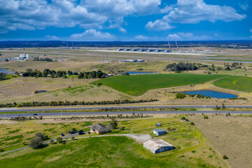 Drone aerial photograph of the new Western Sydney International Airport near agricultural farmland in the Greater Western Sydney suburb of Badgerys Creek in New South Wales, Australia. 