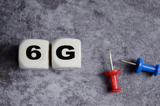 6G on stacked wooden cubes on the table. Business and finance concept