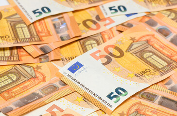 Background of fifty euro bills scattered on table