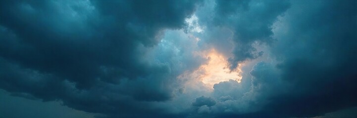 Obraz premium Dramatic stormy sky with dark clouds and ominous light, perfect for weather apps, websites, or presentations needing a powerful atmospheric backdrop , digital background, thunderclouds, powerful