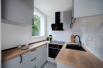 Small modern kitchen in an apartment building.	
