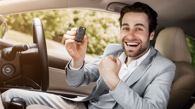 New car, rent transport, buying auto, positive emotions of buyer, good ad and great offer. Happy excited millennial caucasian male in suit showing keys, sits on seat in cabin automobile, free space