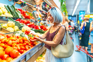 Senior woman selecting fresh produce at supermarket