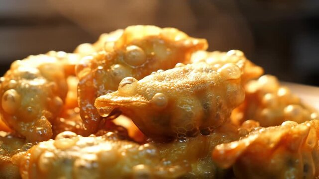 Sizzling Golden Fried Dumplings Glistening with Bubbling Sweet Syrup in Macro Slow Motion