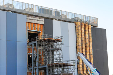 Exterior of a high-density data center campus under construction with scaffolding, cooling units, and structural components for advanced technology and cloud infrastructure operations