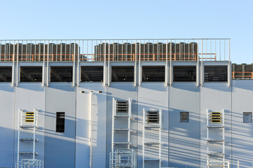 Exterior view of a high-density data center campus under construction, featuring cooling infrastructure, structural walls, and industrial components for advanced technology operations